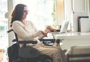Disabled computer user enjoying Morphic's accessibility features to make using a computer easier.